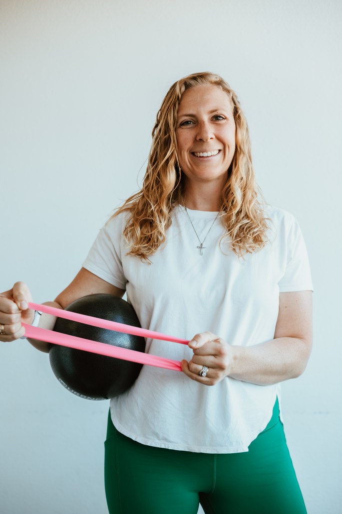 image of dr Micaela Dulgoz smiling and holding an expertise ball and band